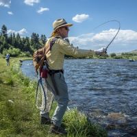 Man fishing on the bank of a river