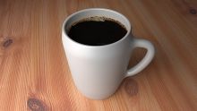 Cup of coffee on wooden table