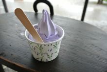 Cup of soft serve ice cream on outdoor table